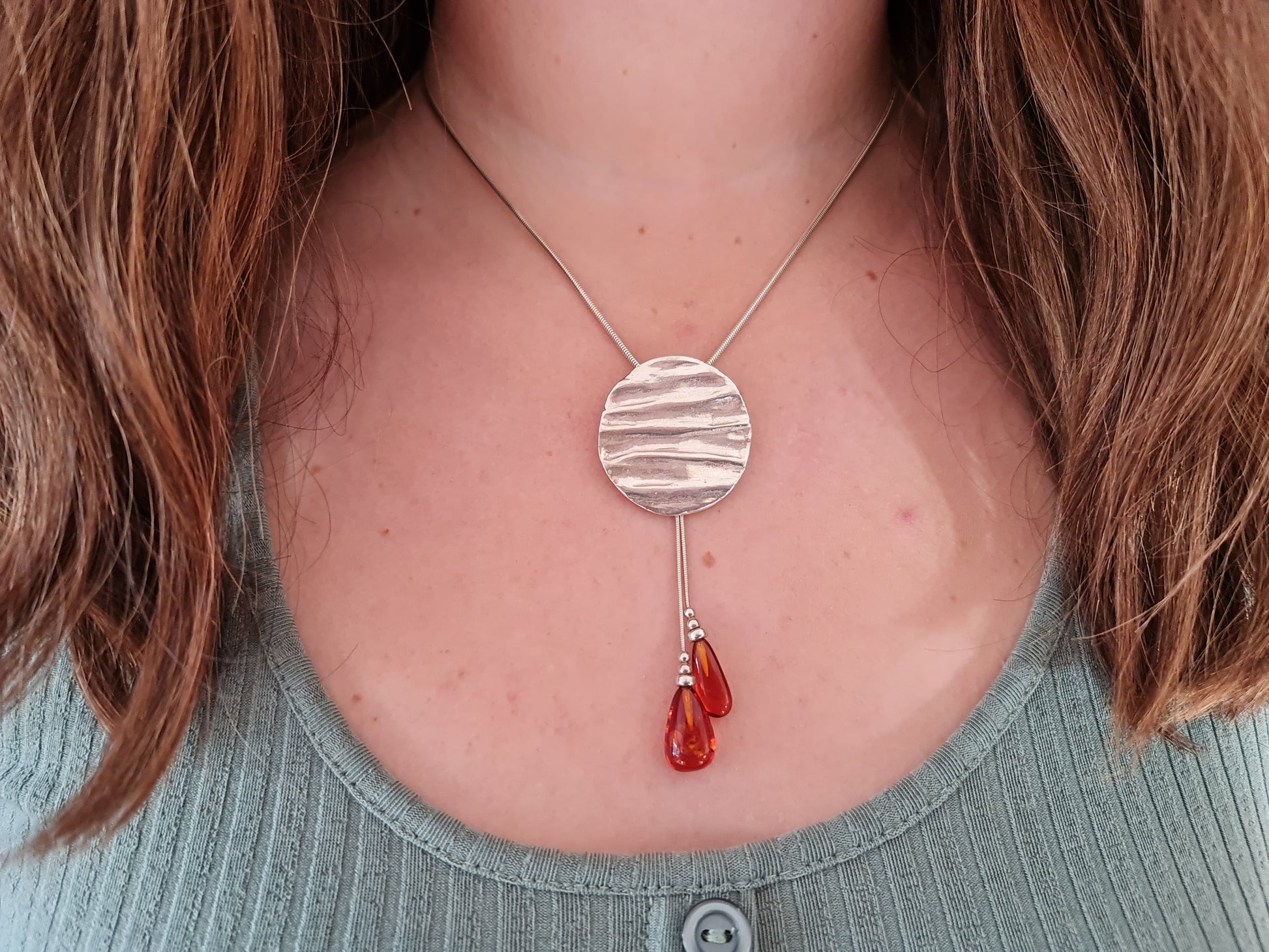 Textured sterling silver handmade pendant with amber beads