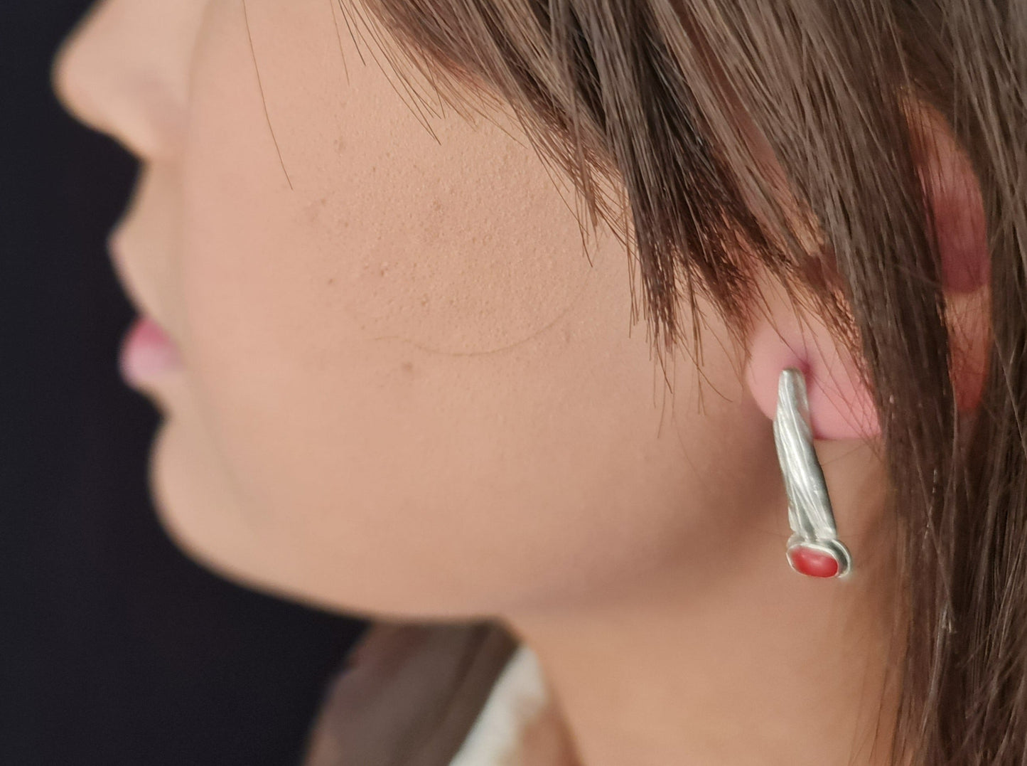 Quarrywood bark polished silver long hang earrings with coral modelled on a female