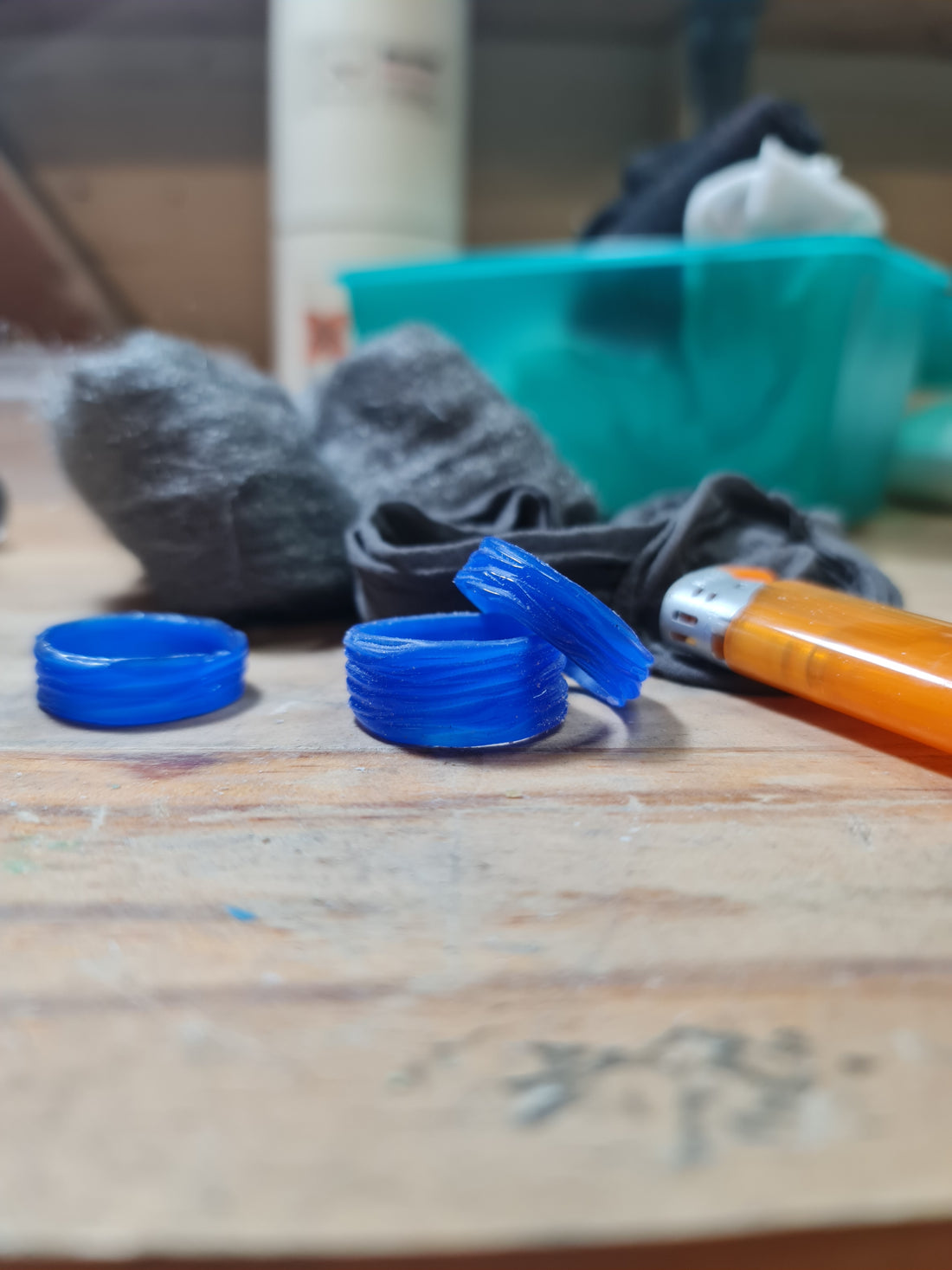 Wax carving tools and blue jewellers wax sitting on a jewellers bench ready to start work on in Kara Jewellery by Charlotte's workshop