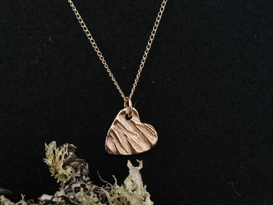 9ct gold heart pendant with a tree bark texture on light weight gold chain