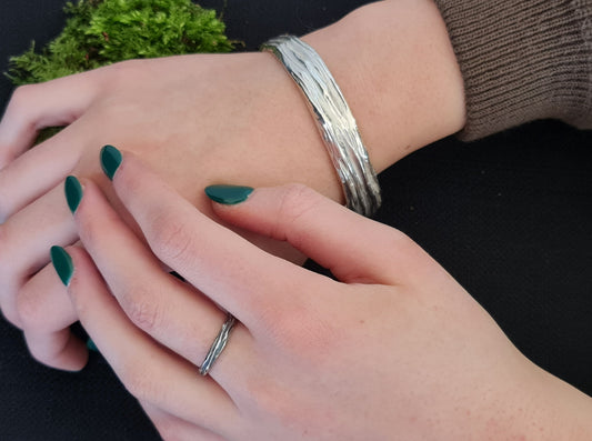 model wearing the Beech wood silver chunky bangle with a tree bark texture