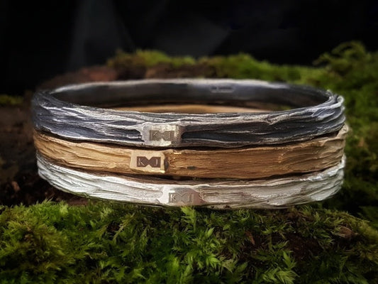 Beech wood bangles stacked in polished silver, bronze and oxidised silver