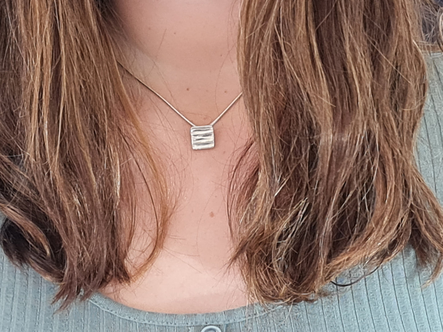 Henhurst polished silver small square pendant necklace modelled on female neck