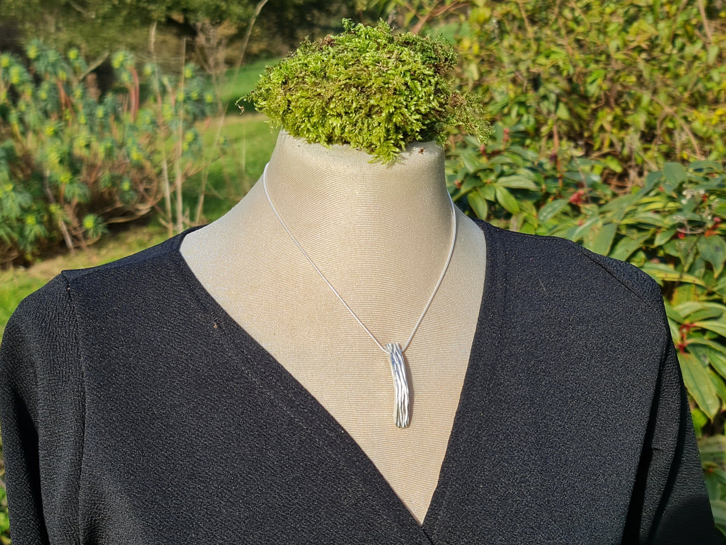 Solid sterling silver tree bark curved rectangular pendant on a silver chain.